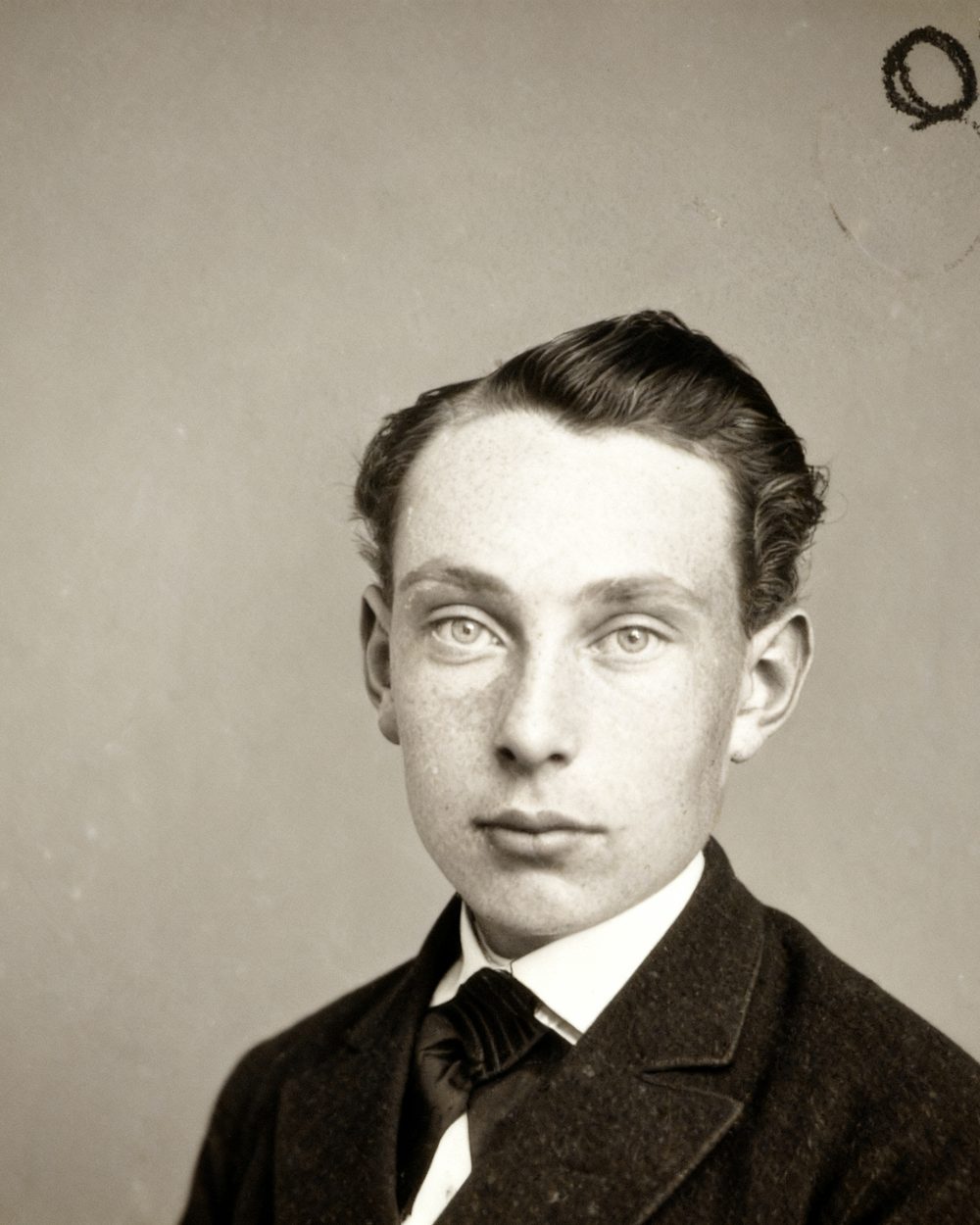 The same young man with the spotting and scratches cleanly removed.