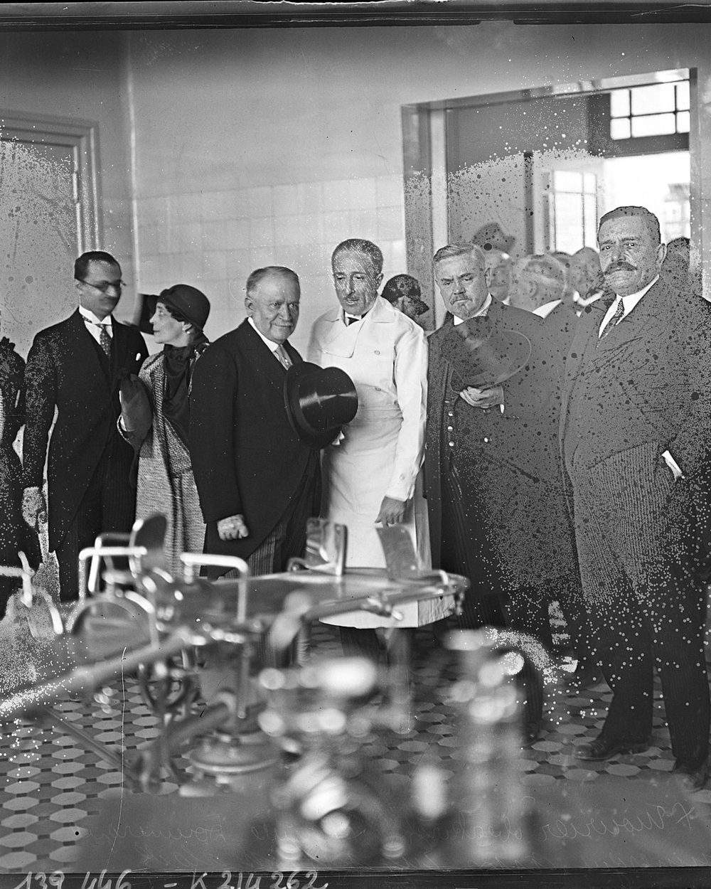 A 1929 group photograph speckled with white damage across the whole frame.